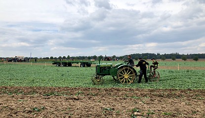 Image showing Children learn how to use an old tractor and plow during the World Ploughing Competition in Germany 2018