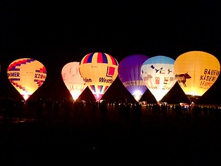 Image showing The glow of hot air balloons at night during the World Ploughing Competition in Germany 2018