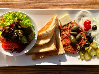 Image showing Steak tartare served with side dishes, toast and salad