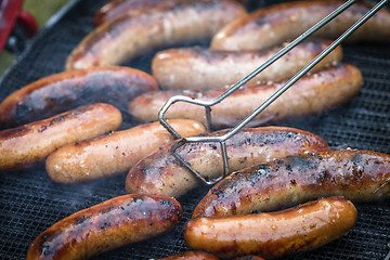 Image showing Crispy wieners on an outdoor grill