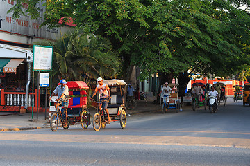 Image showing Traditional rickshaw bicycle with malagasy peoples in Toamasina,