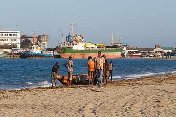 Image showing Malagasy peoples resting on the beach in harbor
