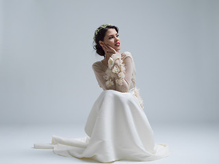 Image showing young bride sitting in a wedding dress