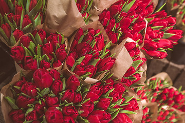 Image showing Red tulip flowers in brown paper bags