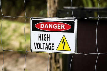Image showing High voltage sign on a fence