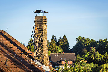 Image showing Old chimney with a ladder on a roof