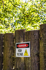 Image showing High voltage sign on a wooden fence