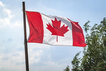 Image showing Canada flag on a flagstaff with the flag waving