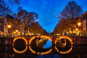 Image showing Amterdam canal, bridge and medieval houses in the evening