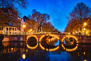 Image showing Amterdam canal, bridge and medieval houses in the evening