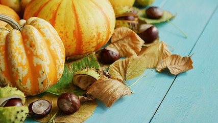 Image showing Pumpkins decorated with chestnuts and leaves