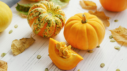 Image showing Yellow pumpkins and dried leaves