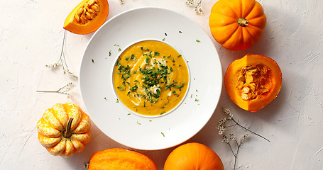 Image showing Pumpkin soup in plate with vegetables around