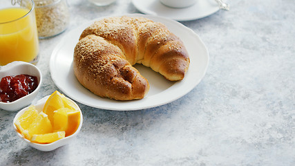 Image showing Delicious croissant with juice