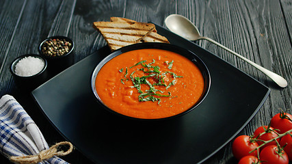 Image showing Tomato soup in bowl with crisp bread