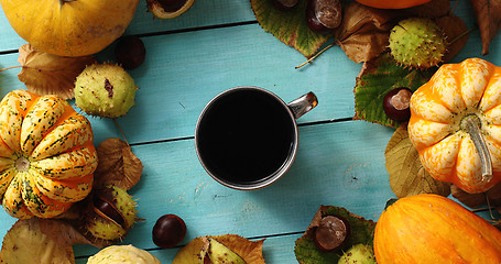 Image showing Cup of coffee surrounded by pumpkins