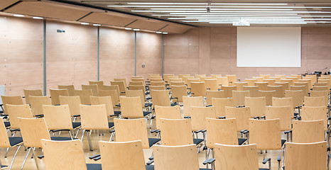 Image showing Empty wooden seats in a cotmporary lecture hall.