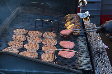 Image showing Chef making beef burgers outdoor on open kitchen international food festival event.