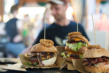 Image showing Chef making beef burgers outdoor on open kitchen international food festival event.