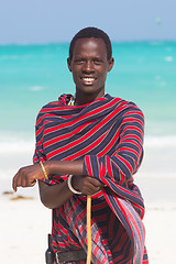 Image showing Traditonaly dressed maasai black man on picture perfect tropical Paje beach, Zanzibar, Tanzania, East Africa.