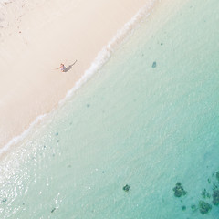 Image showing Aerial shot of woman enjoying the picture perfect white tropica beach on Mauritius island.