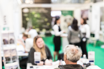 Image showing Anonymous blurred people discussing business at a trade fair.