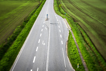 Image showing Highway road with white stripes with rural fields