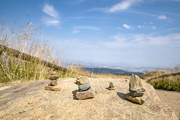 Image showing Small pebble stacks balancing on a large rock