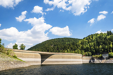 Image showing River with a dam surrounded by hills