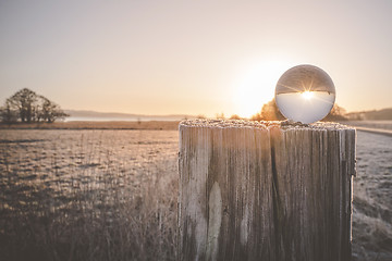 Image showing Winter sunrise with sun in a glass orb