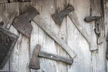 Image showing Old axes hanging on a wall