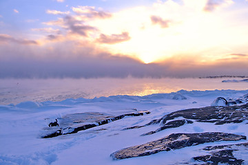 Image showing Sunset and cold fog spreads over freezing northern sea