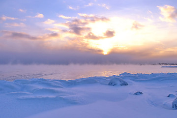 Image showing Sunset and cold fog spreads over freezing northern sea