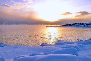 Image showing Sunset and cold fog spreads over freezing northern sea