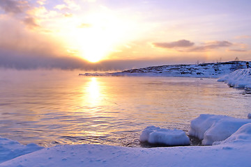 Image showing Sunset and cold fog spreads over freezing northern sea