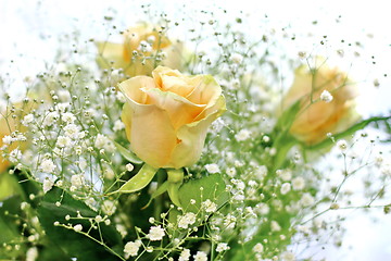 Image showing Beautiful bouquet of yellow roses and white little flowers with blur background