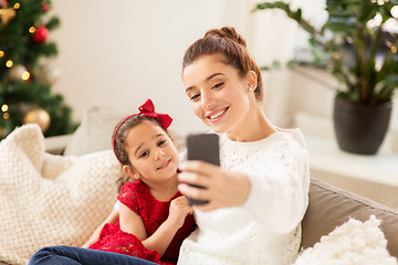 Image showing family taking selfie by smartphone at home