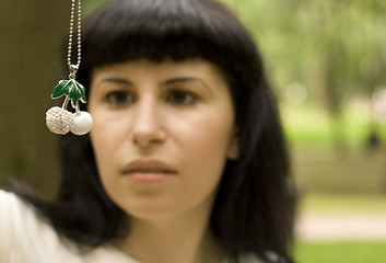 Image showing brunette with jewelery cherry