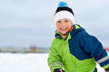 Image showing happy little boy in winter clothes outdoors