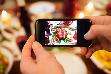 Image showing hands photographing food at christmas dinner