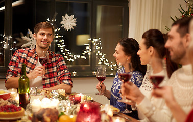 Image showing friends celebrating christmas and speaking toast