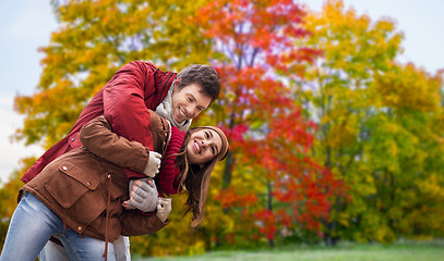 Image showing happy teenage couple hugging in autumn park