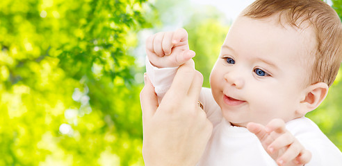 Image showing close up of sweet little baby with mother hand