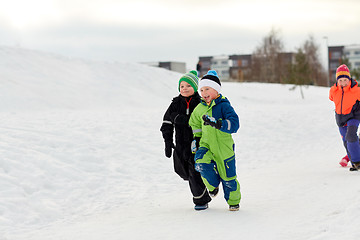 Image showing happy little kids running outdoors in winter