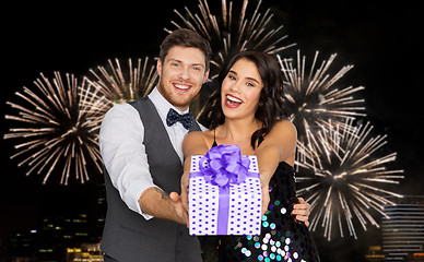 Image showing happy couple with gift box at birthday party