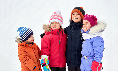 Image showing happy little kids in winter clothes outdoors