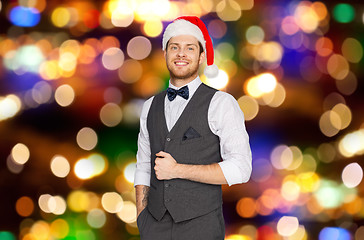 Image showing happy man in santa hat and suit on christmas