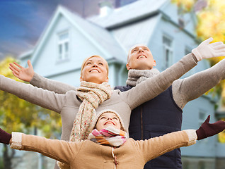 Image showing happy family over living house in autumn