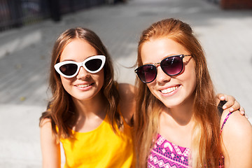 Image showing smiling teenage girls in sunglasses outdoors