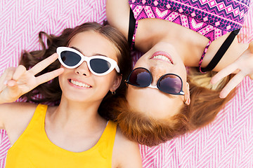 Image showing teenage girls in sunglasses showing peace sign